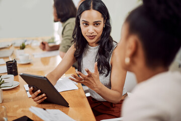 Poster - Do you get what Im saying. a young businesswoman using a digital tablet while having a discussion with a colleague in an office.