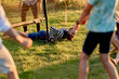 © Flamingo Images - Laughing family playing volleyball outdoors
