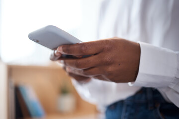 Poster - Ambition waits for no one. an unrecognisable businesswoman using a smartphone in a modern office.