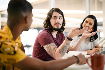 Aufkleber - Giving his opinion. a young businessman having a discussion with his colleagues in an office.