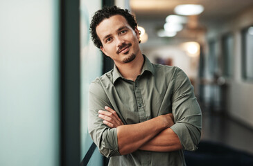 Aufkleber - A creative mind is always working. a handsome young businessman standing alone in the office with his arms folded.