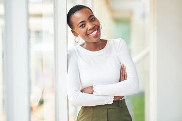 The better business is going the brighter my smile. Portrait of a confident young businesswoman working in a modern office.