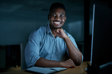 Fototapete - Without dedication, do you even love your job. Portrait of a young businessman using a computer during a late night at work.