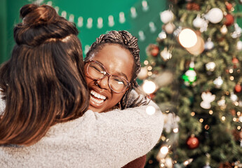 A special day deserves to be spent with special people. two happy young women hugging each other during Christmas at home.