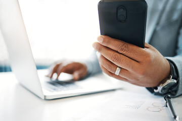 Poster - Keeping on top of everything. an unrecognisable businessman sitting alone in the office and using technology.