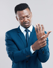 Sticker - Could this be carpal tunnel syndrome. Studio shot of a young businessman experiencing wrist tension against a grey background.