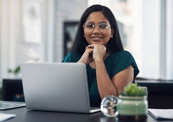 Poster - Im having the most productive day. Portrait of a young businesswoman working on a laptop in an office.