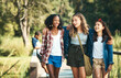 © N F/peopleimages.com - Making new friends and making lots of memories. a group of teenage girls walking and chatting in nature at summer camp.