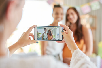 Canvas Print - Sharing the love with friends. a group of women taking photos at their friends baby shower.