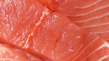 Wall Mural - red fish slices, rotation in circle. salmon slices Turning. selective focus