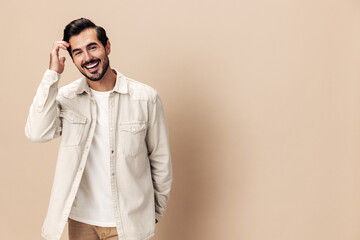 Portrait of a stylish man smile with teeth happiness opened his mouth in surprise on a beige background in a white t-shirt looks at the camera, fashionable clothing style, copy space, Generative AI