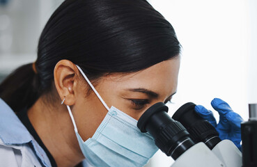 Canvas Print - Looking at things from a different perspective. a young female researcher working in a laboratory.