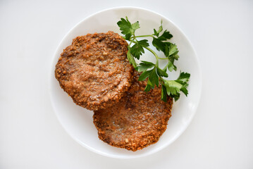 Two meat patties on a white plate. Meat breakfast.