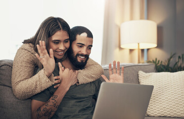 Sticker - The best way to survive social distance. a young couple using a laptop to make a video call on the sofa at home.