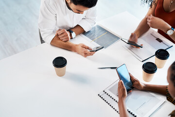 Leinwandbilder - Technology makes up this business. High angle shot of an unrecognizable group of businesspeople sitting in the office together and texting on their cellphones.