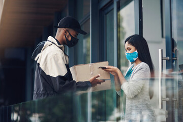 Poster - Home deliveries made safer with smart technology. a masked young man and woman using smartphones during a home delivery.