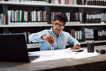 Aufkleber - To be successful youve got to see the bigger picture. a young architect using a compass to draw a building plan.
