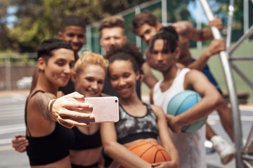 Poster - Sport can be a great way to make long lasting friendships. a group of sporty young people taking selfies together on a sports court.