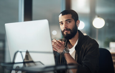 Aufkleber - Until the task is done, Im staying right here. a young businessman using a computer during a late night in a modern office.