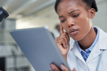 Sticker - Science is all about problem solving. a young scientist using a digital tablet in a lab.