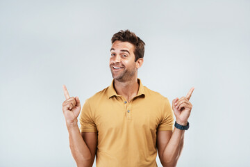 Poster - Pick me, Im your guy. Portrait of a young man with a excited facial expression while standing against a grey background.