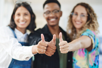 Canvas Print - Were all in agreement. Closeup shot of a group of businesspeople showing thumbs up in an office.