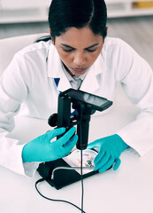 Poster - Digital microscopes make analysing samples much simpler. High angle shot of an attractive young female scientist using a digital microscope while working in a laboratory.