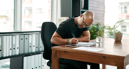 Aufkleber - A tiny detail can change the whole design. a mature businessman filling out paperwork at his desk in a modern office.