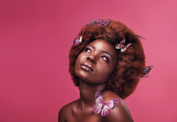 Canvas Print - Splendorous isnt she. Studio shot of a beautiful young woman posing topless with butterflies in her hair against a purple background.