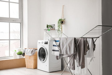 Poster - Interior of laundry room with washing machine, basket and dryer