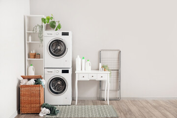 Wall Mural - Interior of laundry room with washing machines, table and basket