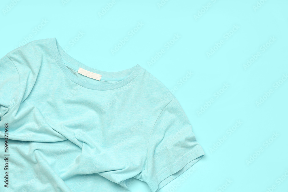 Crumpled blue t-shirt on color background