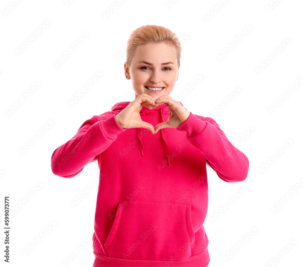 Young woman making heart with her hands on white background