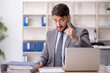 © Elnur - Young male employee working in the office
