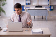 © Elnur - Young male employee working in the office