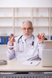 © Elnur - Old male doctor cardiologist working in the clinic