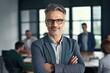 © Adriana - Smiling confident mature businessman looking at camera standing in office. Elegant stylish corporate leader successful ceo executive manager wearing glasses. Generative ai