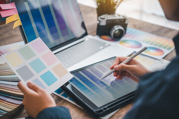 Fototapete - Graphic designer architects who work with laptops and color comparison tables for design work..