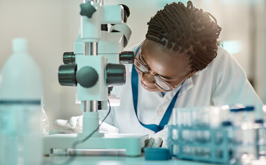 Wall Mural - testing the hypotheses through experiments and observations. a young scientist using a microscope in