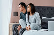 © Nicholas Felix/peopleimages.com - Coupled up in quarantine. a young couple looking thoughtful while recovering from an illness in bed at home.