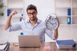 © Elnur - Young male employee in time management concept