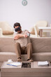 © Elnur - Young man enjoying virtual reality at home