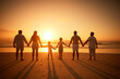 © Alexis Scholtz/peopleimages.com - Rear view of multi generation family silhouetted on the beach. Carefree family with two children, two parents and grandparents holding hands and watching the sunset at the beach
