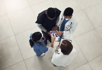 Sticker - We need to have a quick meeting. a group of doctors and nurses using a digital tablet during their meeting.