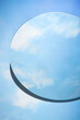 © Tuan  Nguyen  - Abstract minimal scene with round mirror placed on blue background. The mirror reflects the clear blue sky and white clouds. Copy space