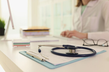 Sticker - Stethoscope lies on clipboard with treatment plan on table