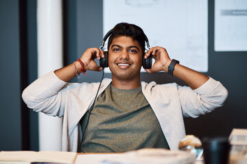 Sticker - Music on, time to make design magic. Portrait of a young architect using headphones while working in a modern office.