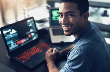 Poster - Moneys my motivator. Portrait of a young man using a laptop in a modern office.