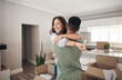 © J Bergen/peopleimages.com - Property, happy couple moving into their new home and boxes in living room. Happiness or smiling, mortgage or homeowners and people hugging celebrating with their new house or apartment together