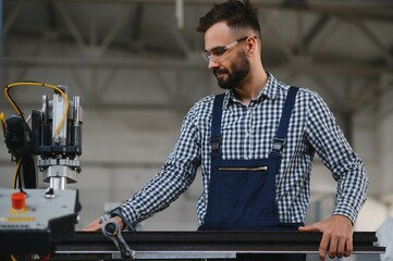 Wall Mural - worker operating machine in factory